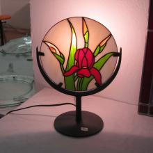 Lampe tiffany ronde avec une fleur rouge allumée