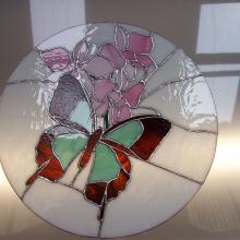 Papillon et fleur sur un vitrail tiffany rond